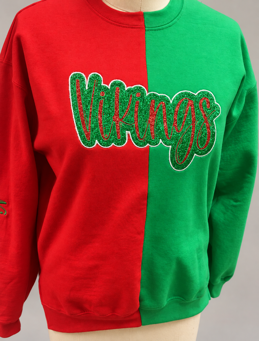 Close-up of the personalized sweatshirt’s double appliqué lettering on a neutral background